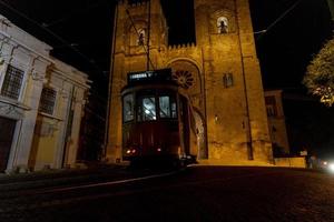 lisbon cathedral night view with tram photo