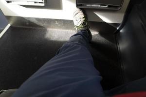 One man leg on airplane photo