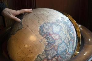 Hand touching earth globe photo