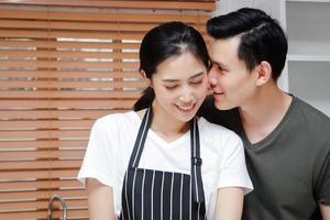 Asian couples cook together in their home kitchens. Living Concept During Covid-19, Social Distance, copy space photo