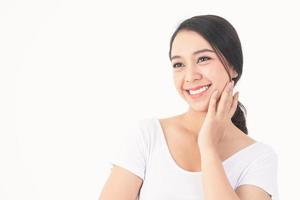 Asian women have beautiful smiles, healthy teeth, strong and clean white. She is wearing a white shirt, white background. Dental care concepts photo