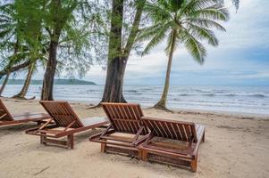 Wooden chair beside the beach with beautiful idyllic seascape view on kohkood island.Koh Kood, also known as Ko Kut, is an island in the Gulf of Thailand photo