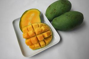 Set of mango cubes and mango slices. photo