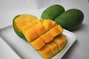 Set of mango cubes and mango slices. photo