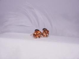 Beautiful gold earrings close-up on a white background photo