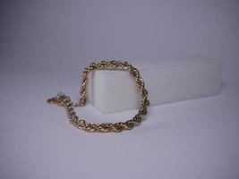 Golden bracelet shot close-up on a white background photo