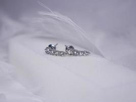 Beautiful gold earrings close-up on a white background photo