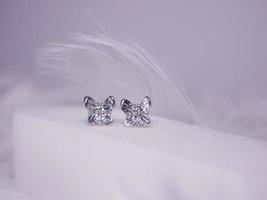 Beautiful gold earrings close-up on a white background photo