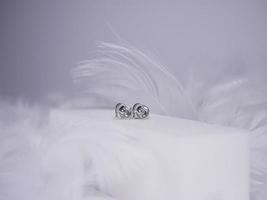 Beautiful gold earrings close-up on a white background photo