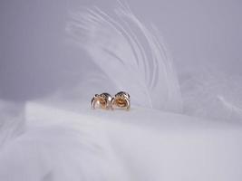 Beautiful gold earrings close-up on a white background photo