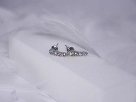 Beautiful gold earrings close-up on a white background photo