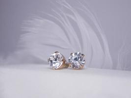 Beautiful gold earrings close-up on a white background photo