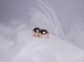 Beautiful gold earrings close-up on a white background photo