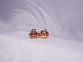 Beautiful gold earrings close-up on a white background photo