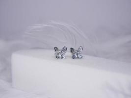 Beautiful gold earrings close-up on a white background photo