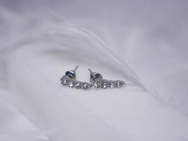 Beautiful gold earrings close-up on a white background photo