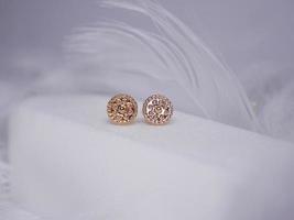 Beautiful gold earrings close-up on a white background photo