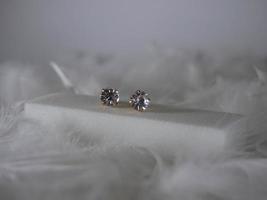 Beautiful gold earrings close-up on a white background photo