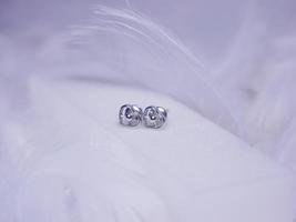 Beautiful gold earrings close-up on a white background photo