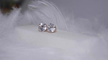 Beautiful gold earrings close-up on a white background photo