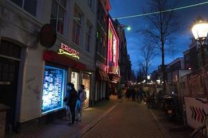 AMSTERDAM, NETHERLAND - FEBRUARY 25 2020 - Red light district in the old town photo