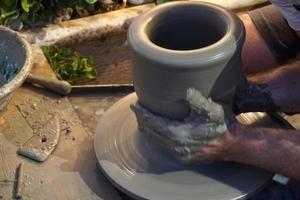 Hands working on pottery closup detail photo