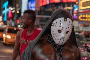 NEW YORK, USA - MAY 25 2018 - masked black man in Times square full of people photo