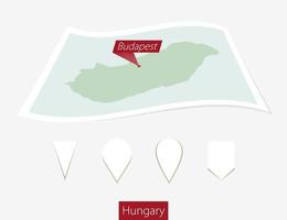 Curved paper map of Hungary with capital Budapest on Gray Background. Four different Map pin set. vector