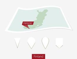 Curved paper map of Finland with capital Helsinki on Gray Background. Four different Map pin set. vector