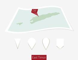 Curved paper map of East Timor with capital Dili on Gray Background. Four different Map pin set. vector