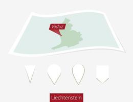 curvo papel mapa de Liechtenstein con capital vaduz en gris antecedentes. cuatro diferente mapa alfiler colocar. vector