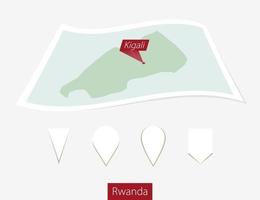 curvo papel mapa de Ruanda con capital kigali en gris antecedentes. cuatro diferente mapa alfiler colocar. vector