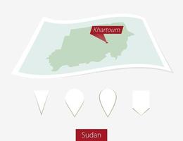 Curved paper map of Sudan with capital Khartoum on Gray Background. Four different Map pin set. vector