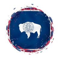 Round grunge flag of Wyoming US state with splashes in flag color. vector