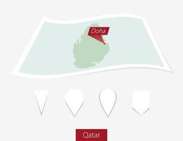 Curved paper map of Qatar with capital Doha on Gray Background. Four different Map pin set. vector