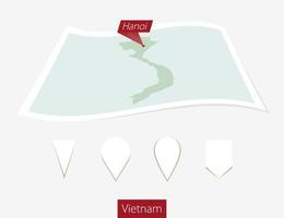 Curved paper map of Vietnam with capital Hanoi on Gray Background. Four different Map pin set. vector