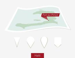 curvo papel mapa de Haití con capital puerto principe en gris antecedentes. cuatro diferente mapa alfiler colocar. vector