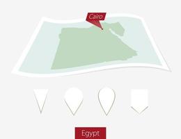 Curved paper map of Egypt with capital Cairo on Gray Background. Four different Map pin set. vector