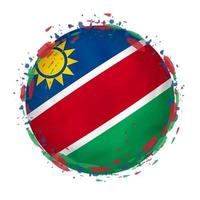 Round grunge flag of Namibia with splashes in flag color. vector