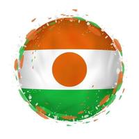 Round grunge flag of Niger with splashes in flag color. vector