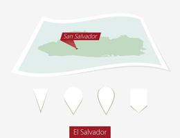 curvo papel mapa de el el Salvador con capital san el Salvador en gris antecedentes. cuatro diferente mapa alfiler colocar. vector