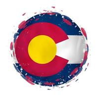 Round grunge flag of Colorado US state with splashes in flag color. vector