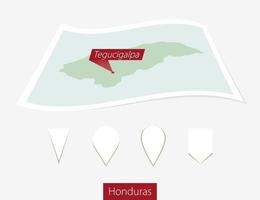 curvo papel mapa de Honduras con capital tegucigalpa en gris antecedentes. cuatro diferente mapa alfiler colocar. vector