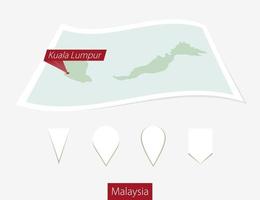 Curved paper map of Malaysia with capital Kuala Lumpur on Gray Background. Four different Map pin set. vector