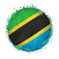 Round grunge flag of Tanzania with splashes in flag color. vector