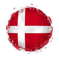 Round grunge flag of Denmark with splashes in flag color. vector