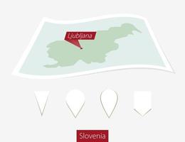 Curved paper map of Slovenia with capital Ljubljana on Gray Background. Four different Map pin set. vector