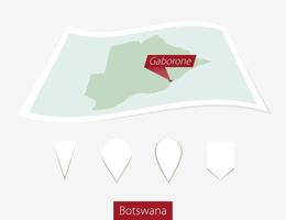 Curved paper map of Botswana with capital Gaborone on Gray Background. Four different Map pin set. vector