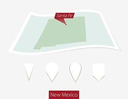 Curved paper map of New Mexico state with capital Santa Fe on Gray Background. Four different Map pin set. vector