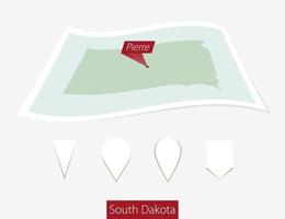 Curved paper map of South Dakota state with capital Pierre on Gray Background. Four different Map pin set. vector